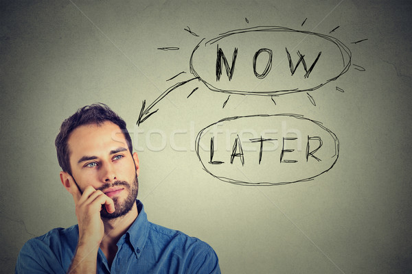 Stock photo: Now or later. Man thinking looking up