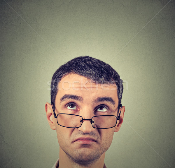 funny confused skeptical man in glasses thinking planning looking up Stock photo © ichiosea
