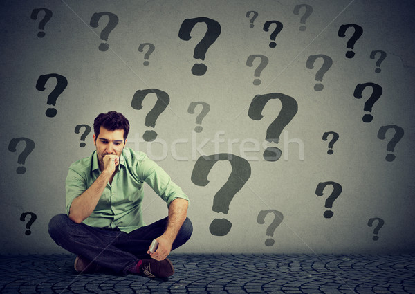 business man sitting on a floor with many questions what to do next Stock photo © ichiosea