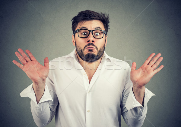 Ignorant man shrugging with shoulders Stock photo © ichiosea