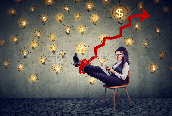 accomplished business woman relaxing sitting in the office under idea money rain Stock photo © ichiosea