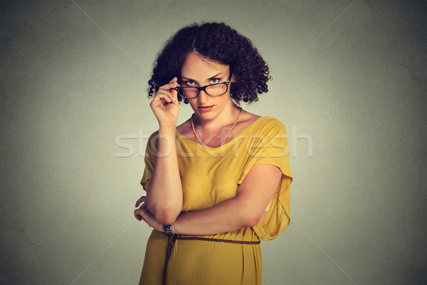 Angry bitchy serious woman with glasses in yellow dress skeptically looking at you  Stock photo © ichiosea