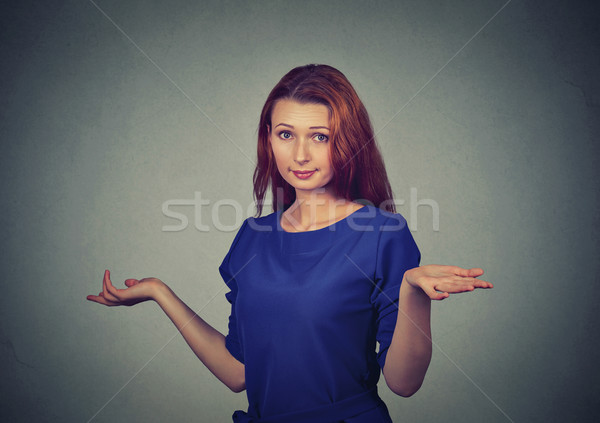 Stock photo: dumb looking woman arms out shrugs shoulders who cares so what I don't know