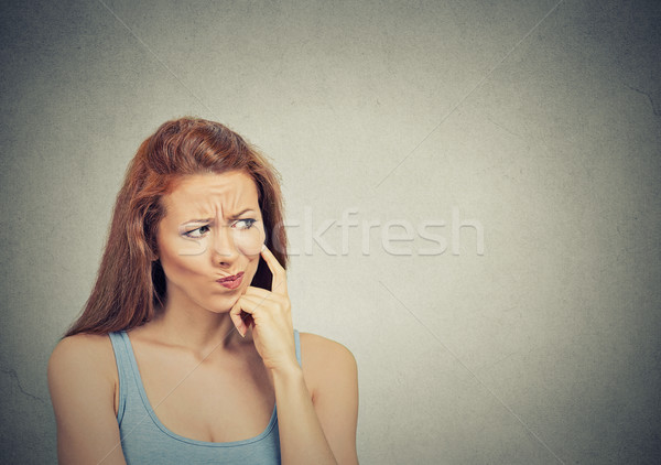 thoughtful skeptical suspicious young woman  Stock photo © ichiosea