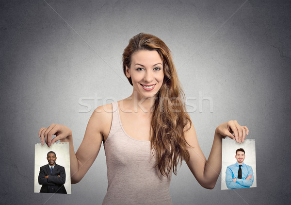 Stock photo: Beautiful woman undecided about which man to choose. Human emotions