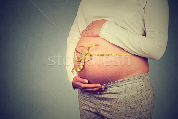 Femme enceinte ruban ventre permanent isolé gris [[stock_photo]] © ichiosea