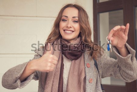 Happy woman holding keys from her new apartment Stock photo © ichiosea