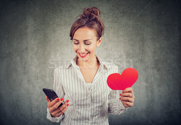 Mutlu kadın bakıyor cep telefonu kırmızı Stok fotoğraf © ichiosea