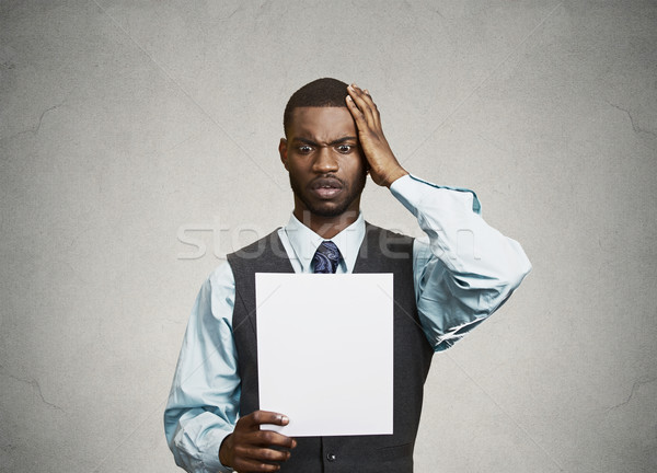 Man holding paper, statement, shocked with bad news Stock photo © ichiosea