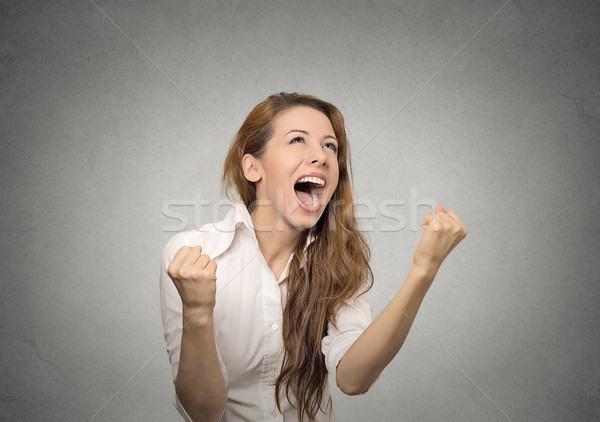 Stock photo: happy woman exults pumping fists celebrates success