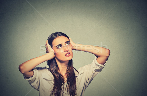 annoyed stressed woman covering her ears, looking up loud noise  Stock photo © ichiosea