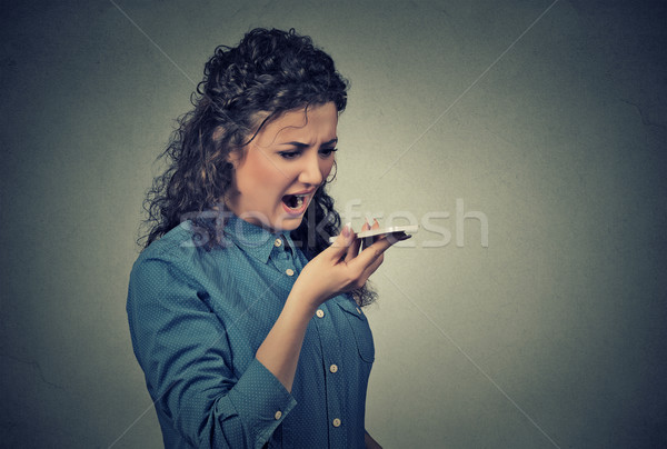 ngry young woman screaming on mobile phone Stock photo © ichiosea