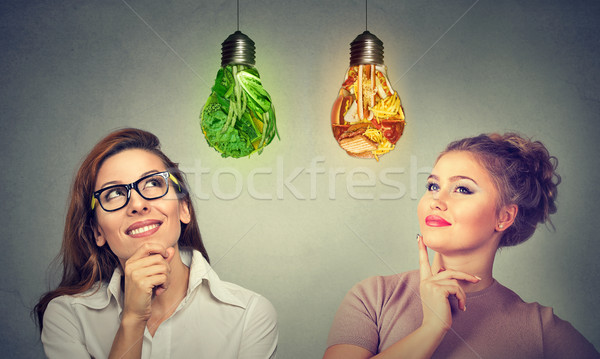 women thinking about diet looking at vegetables junk food lightbulb  Stock photo © ichiosea