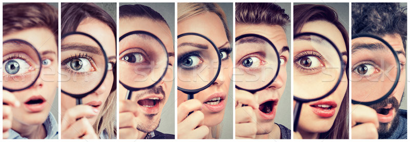 Group of curious women and men looking through a magnifying glass Stock photo © ichiosea
