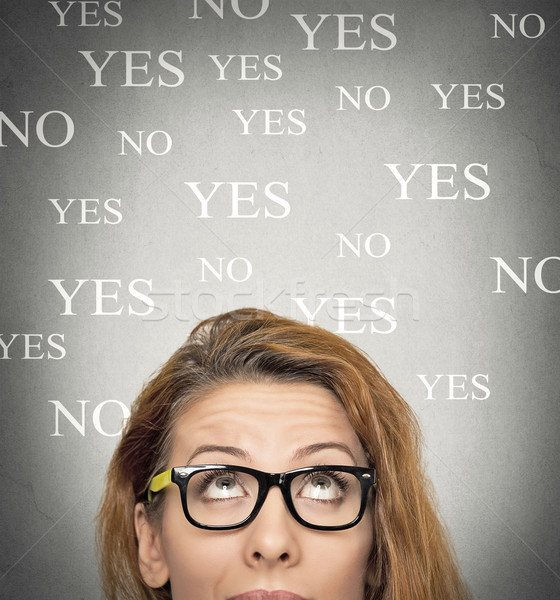 uncertain woman looking up, background with yes no choices Stock photo © ichiosea