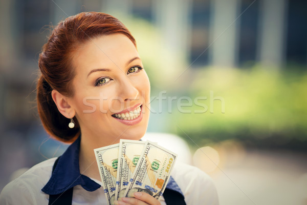  successful young business woman holding money dollar bills in hand Stock photo © ichiosea