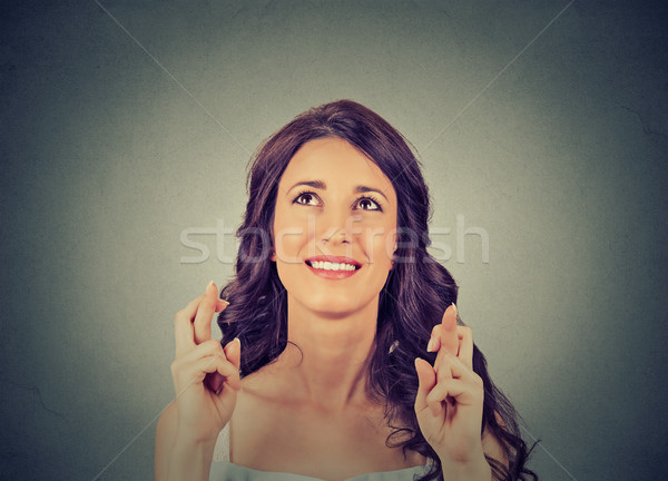 hopeful beautiful woman crossing her fingers, hoping, asking for best looking up Stock photo © ichiosea