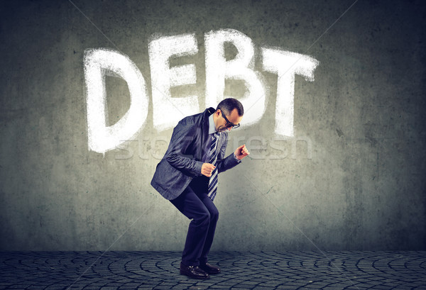 Stressed business man under debt pressure financial burden   Stock photo © ichiosea