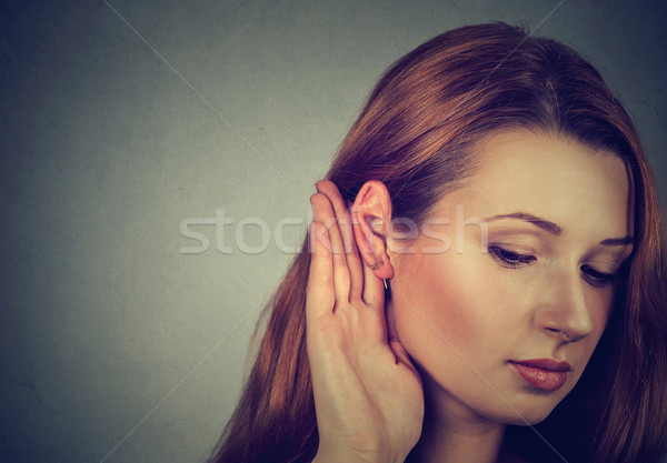 Woman holds her hand near ear and listens carefully  Stock photo © ichiosea