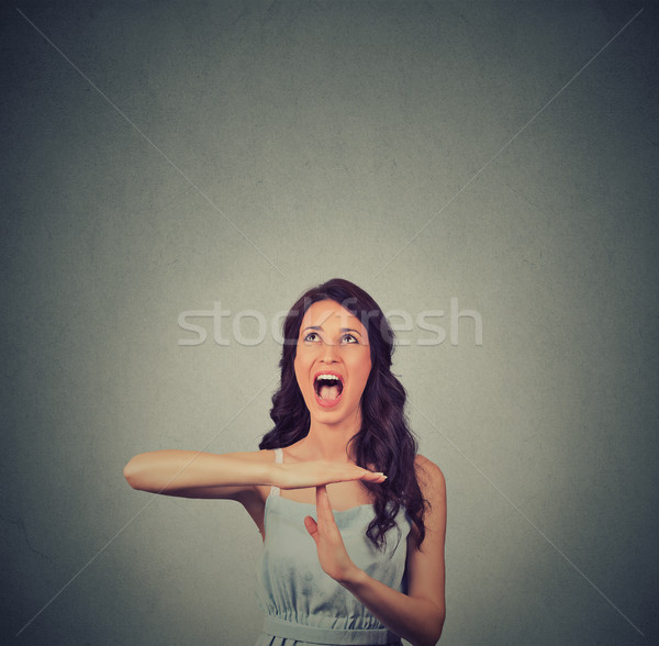 Stock photo: Young woman showing time out hand gesture, frustrated screaming