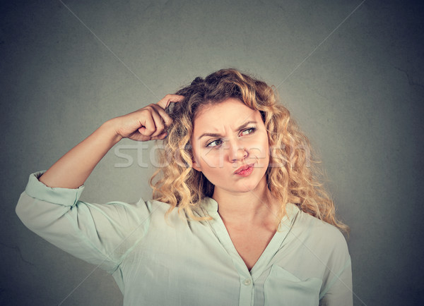 Woman scratching head thinking about something looking up  Stock photo © ichiosea