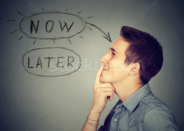 Now or later. Man thinking making up his mind  Stock photo © ichiosea