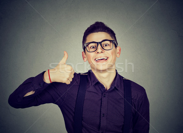Successful teenager. Nerdy man giving thumbs up hand gesture sign  Stock photo © ichiosea