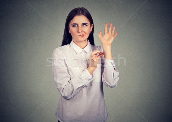 Confused woman pinching herself in disbelief of what just happened   Stock photo © ichiosea