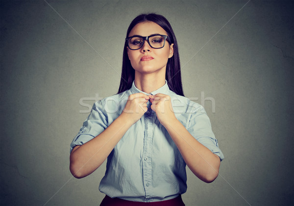 Kobieta przyciski w górę shirt niebieski tle Zdjęcia stock © ichiosea