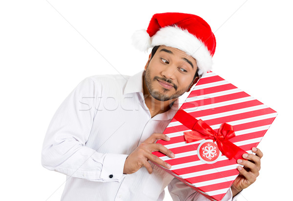 man trying to shake and listen to his wrapped gift Stock photo © ichiosea