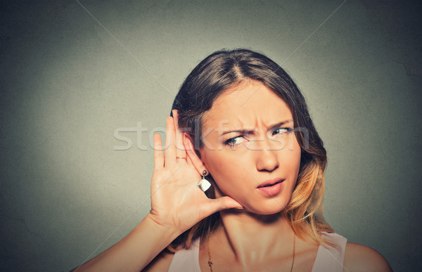 concerned young nosy woman hand to ear gesture carefully secretly listening Stock photo © ichiosea
