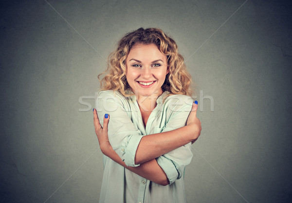Smiling woman holding hugging herself. Love yourself concept Stock photo © ichiosea