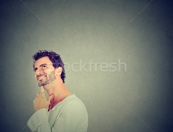Glücklich junger Mann Denken Träumerei nachschlagen isoliert Stock foto © ichiosea