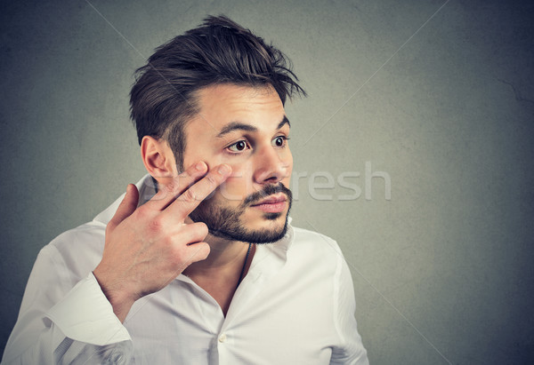 Férfi húz lefelé szemhéj szem néz Stock fotó © ichiosea