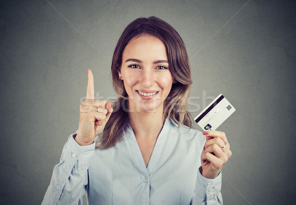 Girl with credit card holding finger up  Stock photo © ichiosea