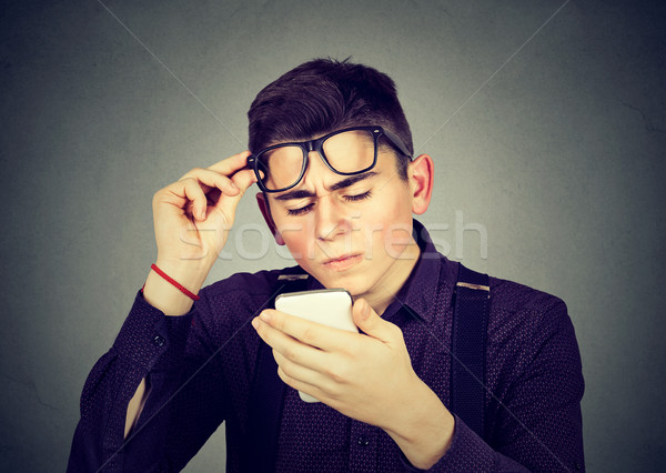 man with glasses having trouble seeing cell phone vision problems Stock photo © ichiosea