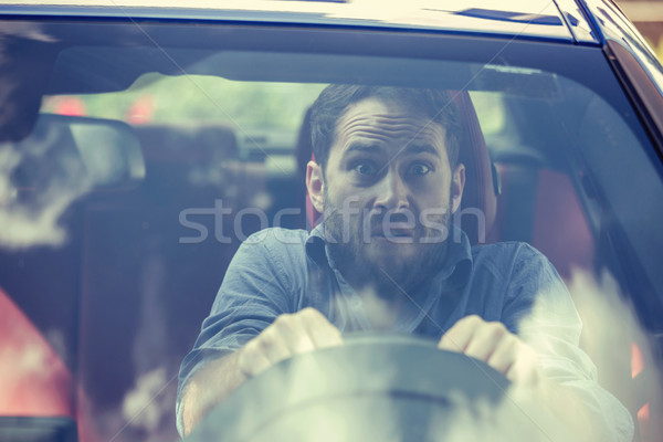 Stressed scared man driver. Inexperienced anxious motorist  Stock photo © ichiosea