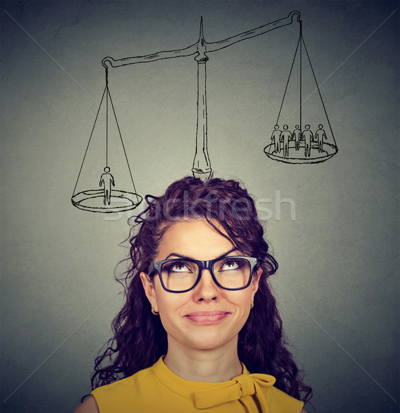 Woman making a decision with scale above head and people on a balance Stock photo © ichiosea