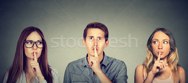 Secretive young people man and two women with finger to lips gesture   Stock photo © ichiosea