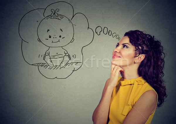 Content woman dreaming of a baby Stock photo © ichiosea