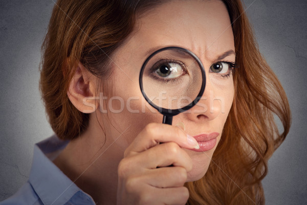 Headshot woman investigator looking through magnifying glass Stock photo © ichiosea