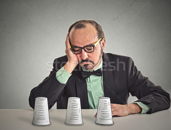 Man with glasses sitting at desk playing a conjuring trick game Stock photo © ichiosea