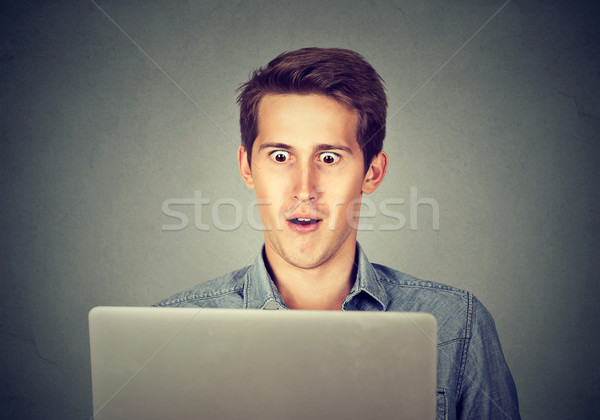 Shocked man looking at laptop  Stock photo © ichiosea