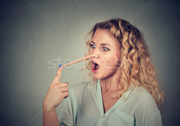 Woman with long nose. Liar concept Stock photo © ichiosea
