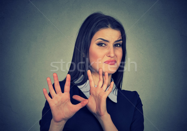 Young woman with disgusted expression dodging something Stock photo © ichiosea