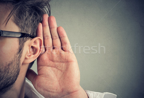 man holds his hand near ear and listens carefully Stock photo © ichiosea