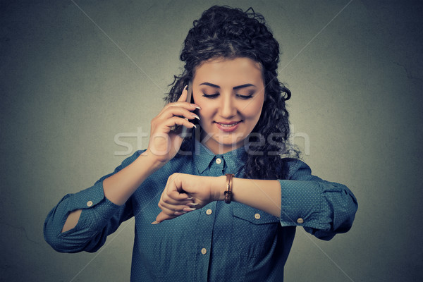 Business and time management. Happy business woman looking at wrist watch, running late for meeting Stock photo © ichiosea