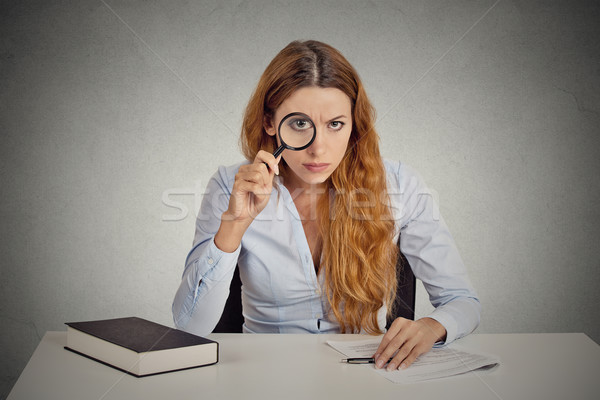woman with glasses skeptically looking at you through magnifying glass  Stock photo © ichiosea