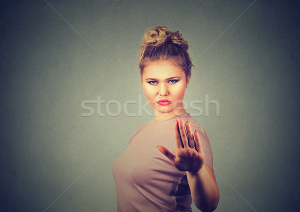 Stock photo: annoyed angry woman with bad attitude giving talk to hand gesture