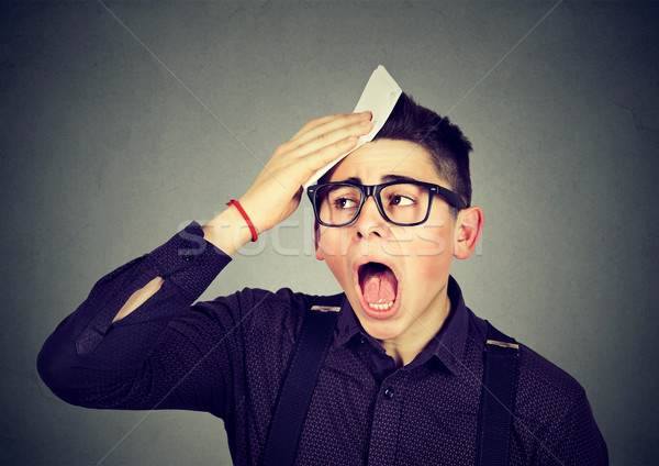 Stock photo: Tired man sweating isolated on gray background 